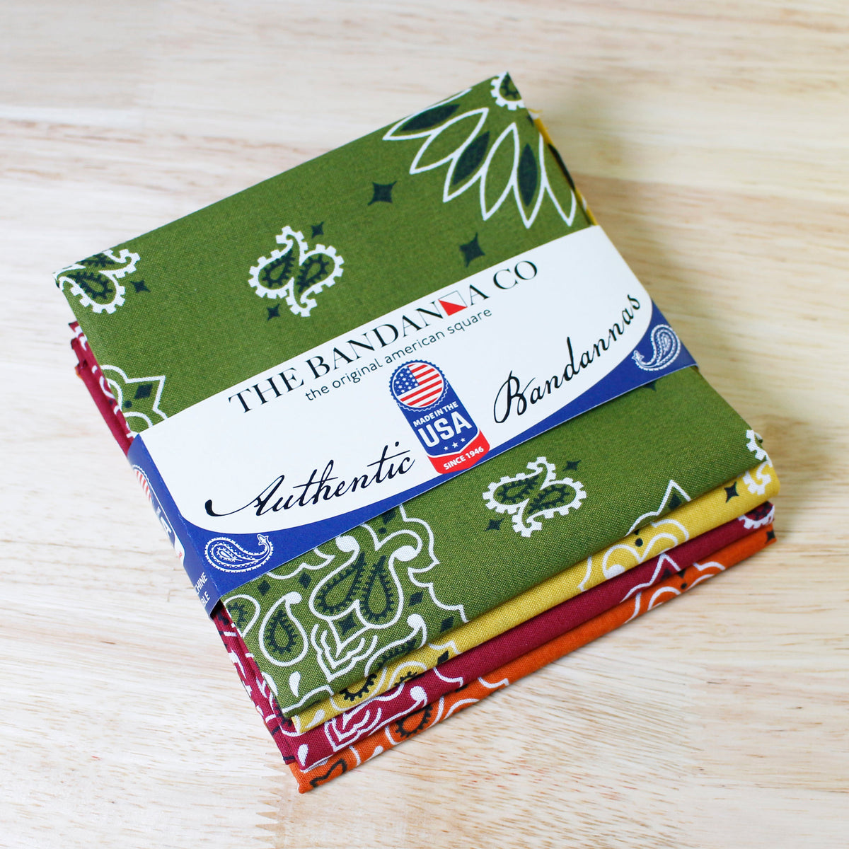 Rustic Bandanna Assortment 4 Pack - Made In The USA displayed on a wooden surface.