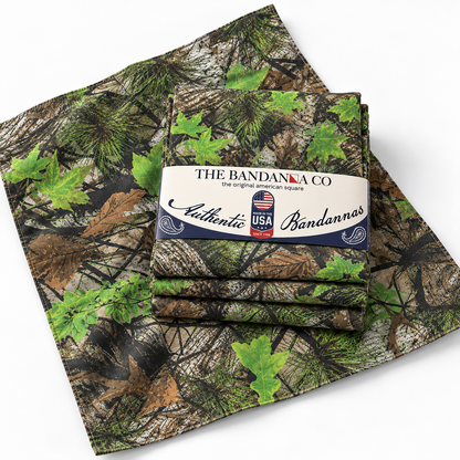 Buck County camo bandanna unfolded showing the maple leaf, pine, and pinecone pattern, with a 4-pack