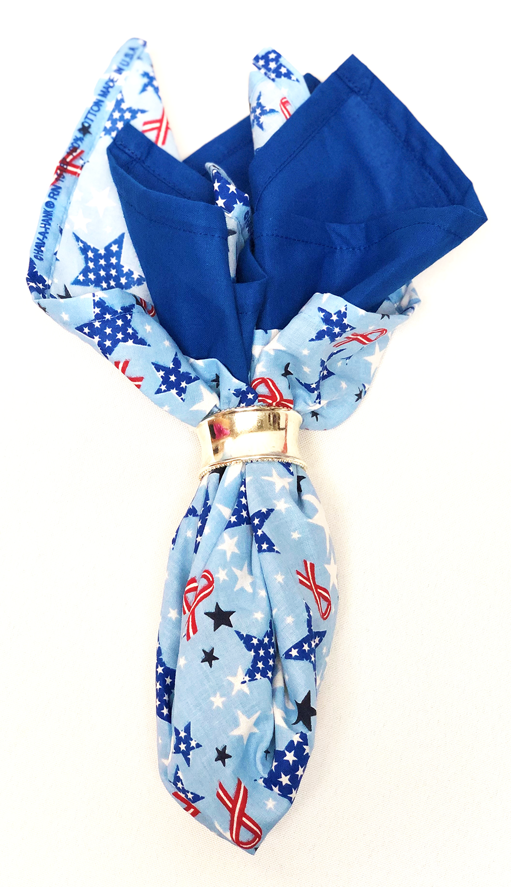 Royal Blue Solid Color Bandanna 4 Pack - Cotton 22x22 displayed in a stylish fold with patterned accents