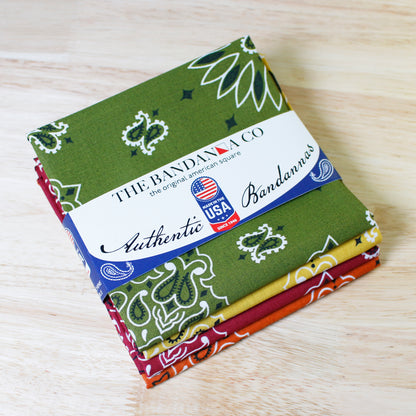 Rustic Bandanna Assortment 4 Pack - Made In The USA displayed on a wooden surface.